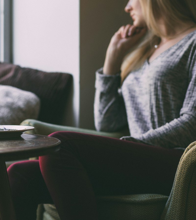 Woman relaxing at home with a warm drink